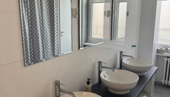 Łazienka – część z umywalkami i lustrami dostępna dla gości schroniska.